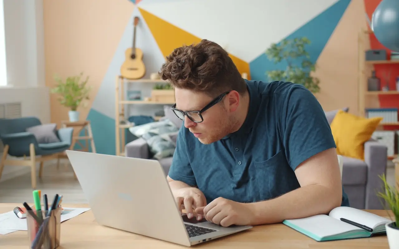 A student working with focus at a bright, colorful home office