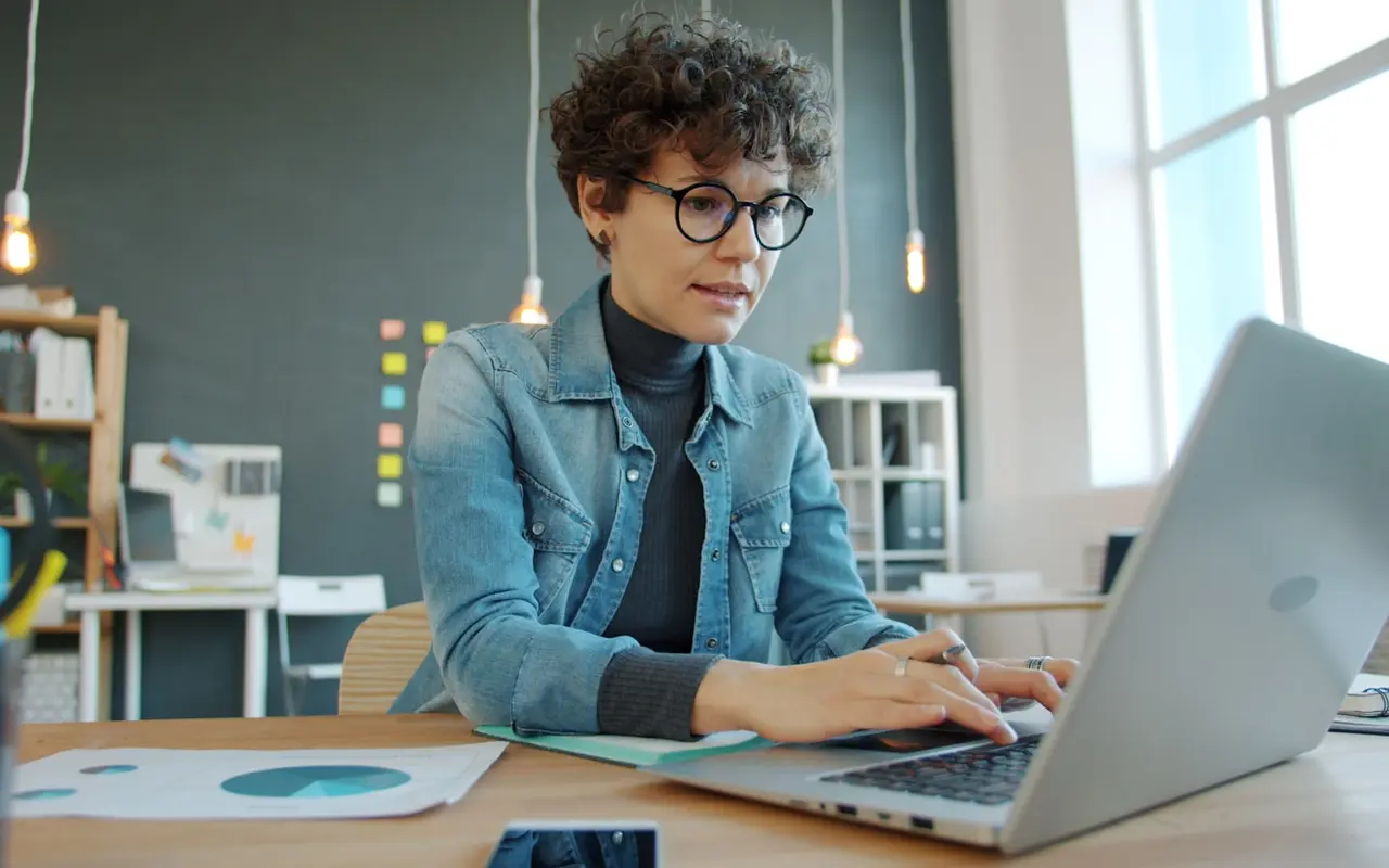 Student focused on research and data at her desk