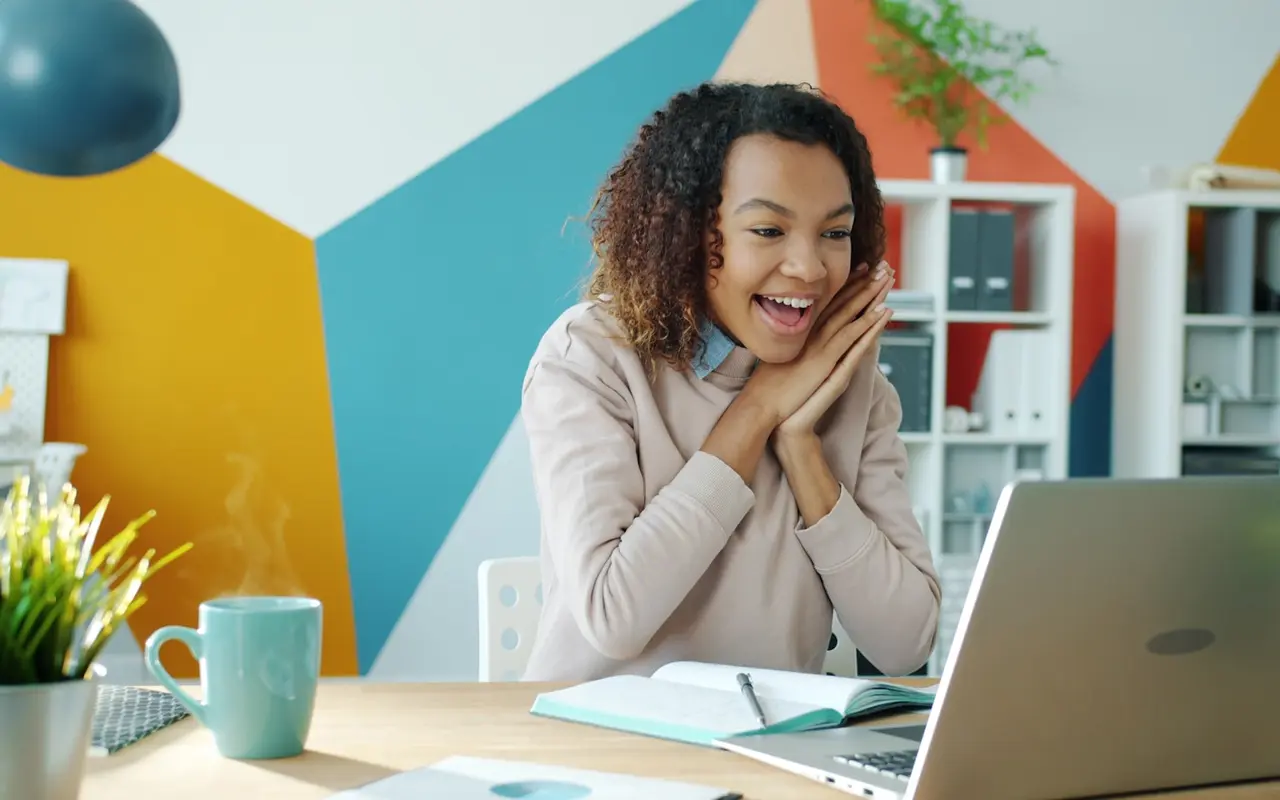 A student reviewing course options on her laptop at home